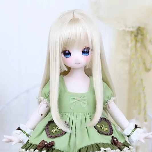 Ball-jointed doll with long blonde hair, blue eyes, and a green dress with bows