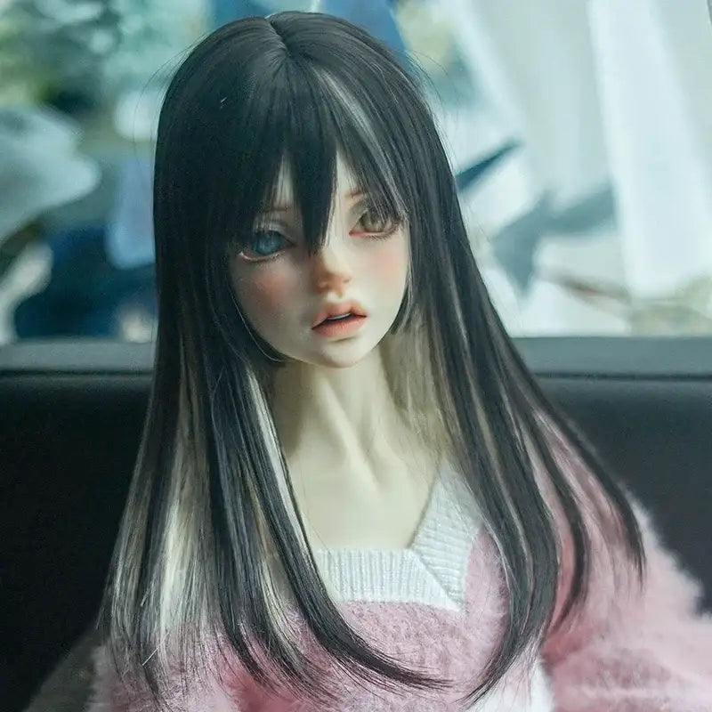 Realistic ball-jointed doll with long black hair and pink sweater, close-up portrait.
