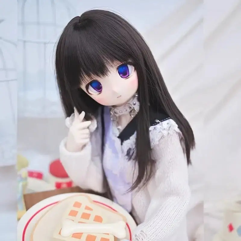 ball-jointed doll with long dark hair, purple eyes, and white sweater beside a plate of food